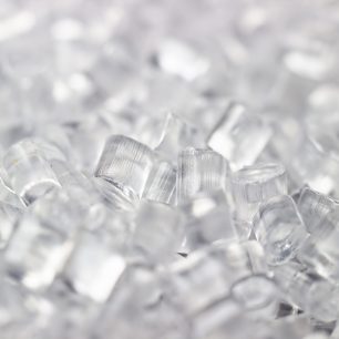 Transparent Plastic in granules. Polymer pellets. Isolated on a black background.